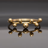 خاتم من الفولاذ الذهبي الفاخر مع 7 كرات عصرية خاتم من الفولاذ الذهبي الفاخر مع 7 كرات عصرية